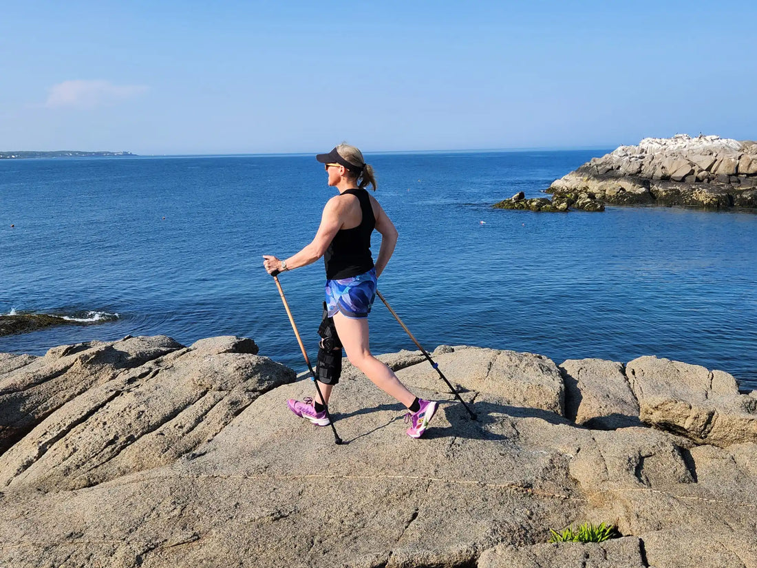 Woman Walking on Rocks with Walking Poles