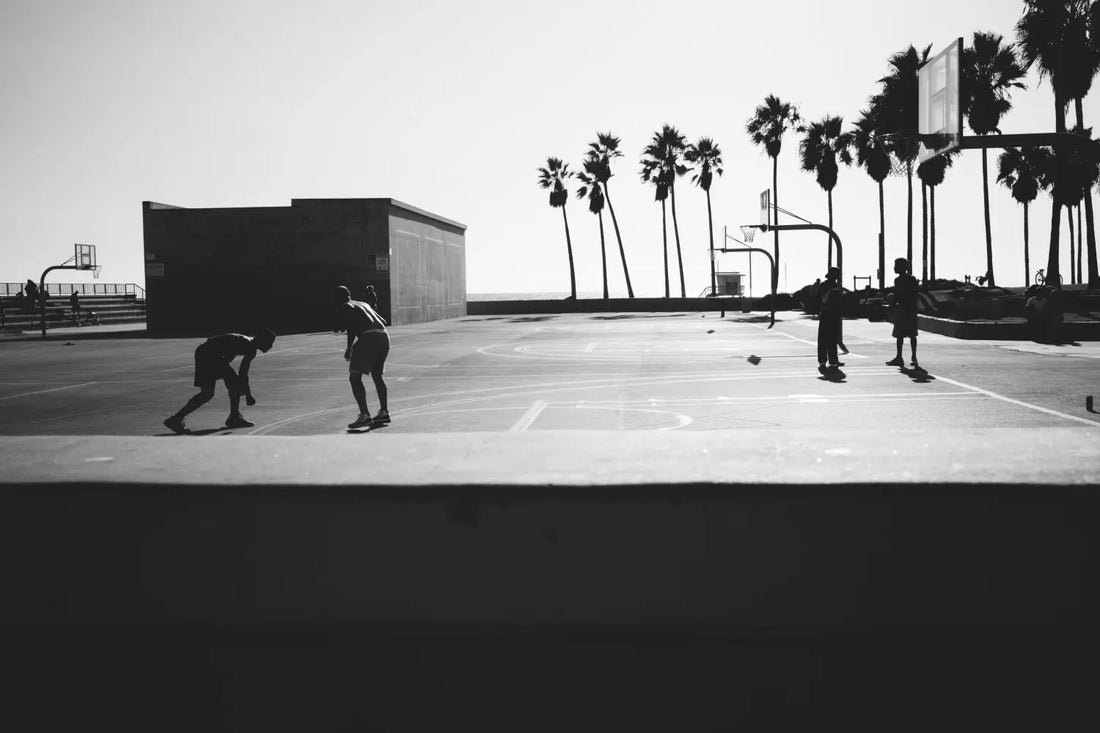 People Playing Basketball Near a Beach