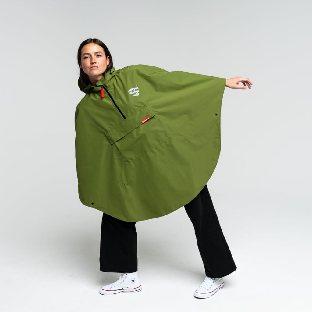 Woman in a rain cape leaning to one side