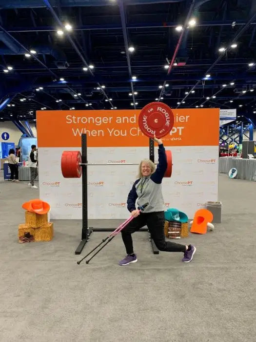 Woman Holding Walking Poles and a Dumbell