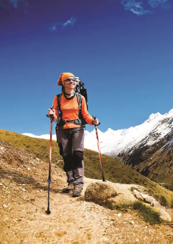 Woman Hiking on a Mountain Trail with Motivator Walking Poles