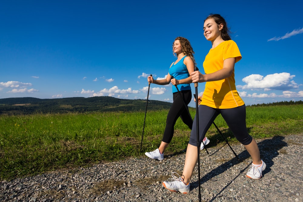 Two People Pole Walking on a graded path