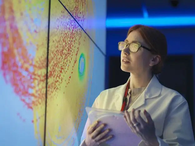 Woman analyzing a wall graphic in a lab